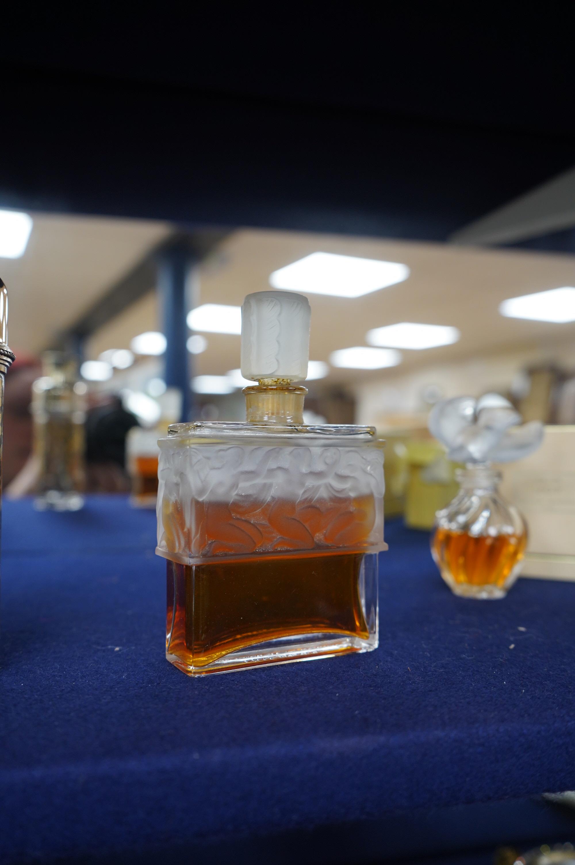 Three Lalique perfume bottles and atomisers, together with two others, tallest 14cm. Condition - fair.